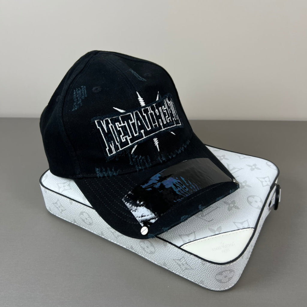 Black distressed cotton cap with metal graphic and glossy shield brim